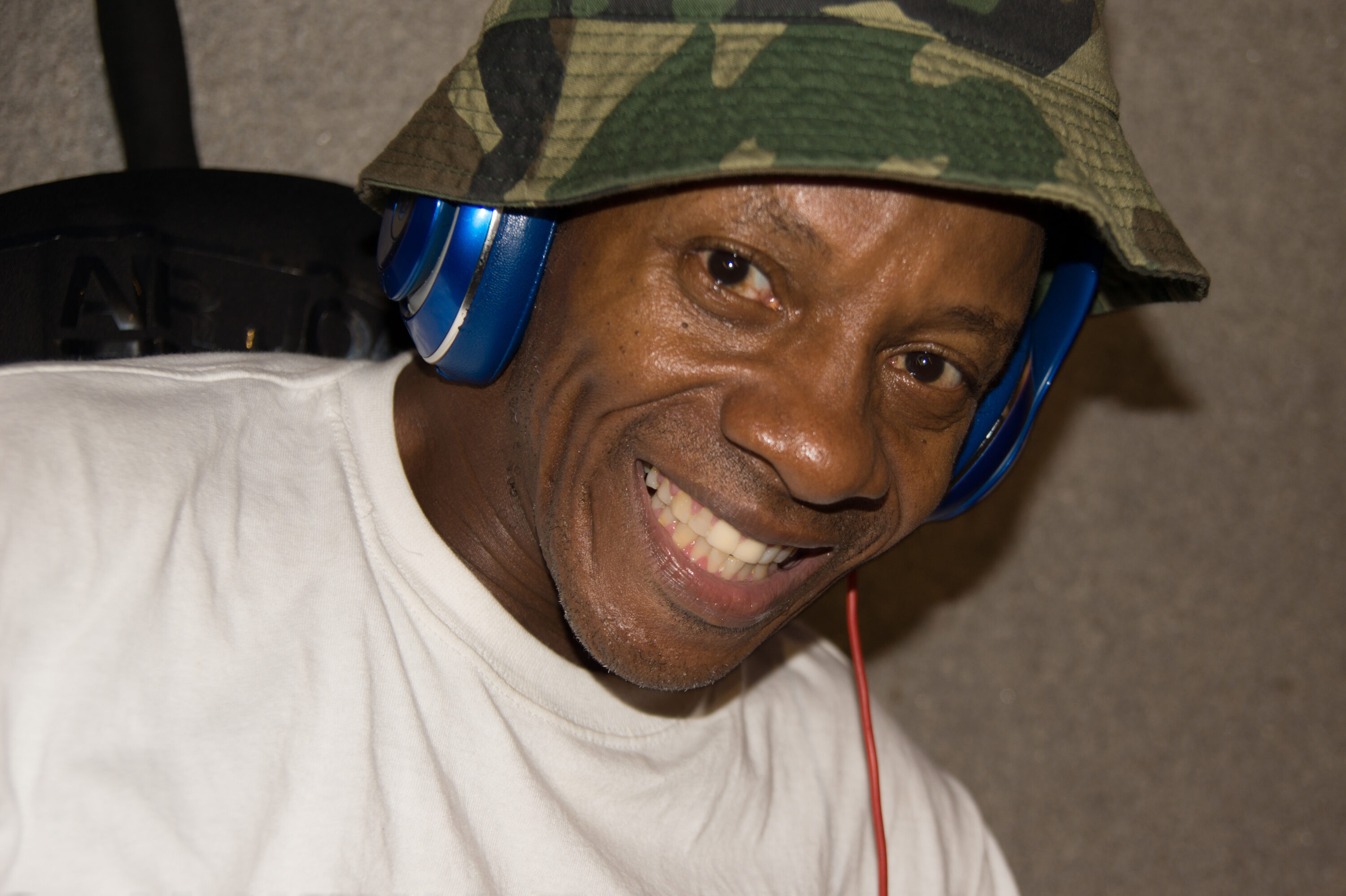 Smiling homeless man next to PATH station in lower Manhattan